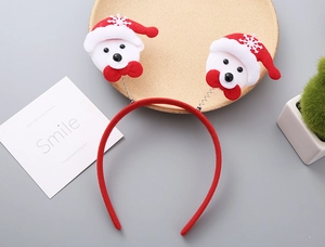 Detail of Christmas headband with Santa bear motifs and springs on a wooden tray