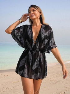Elegant black beach cover-up dress with white leaf print and deep V-neck style