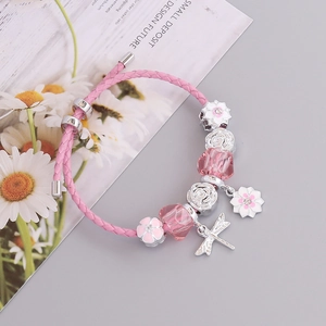 Pink woven leather charm bracelet featuring silver rose beads and dragonfly pendants