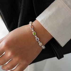 Detail of silver bracelet with colorful oval gemstones and shimmering pavé zircons