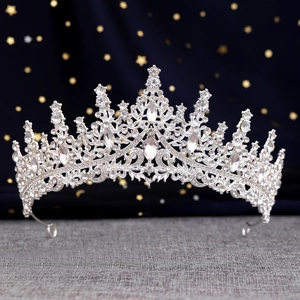 Close-up of a silver bridal crown featuring shimmering crystals on a dark starry background