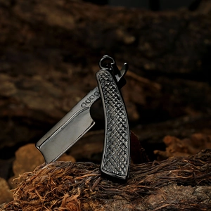 Detailed view of a black barber razor pendant with textured metal finish on wood