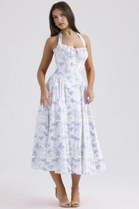 Detail view of a white halter neck maxi dress featuring blue floral print and A-line skirt