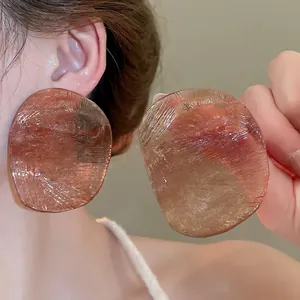 Chic irregular oval resin earrings in amber brown with a brushed texture for women
