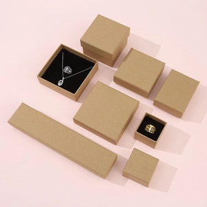 Kraft paper jewelry gift boxes in various sizes on a pink background for rings and necklaces