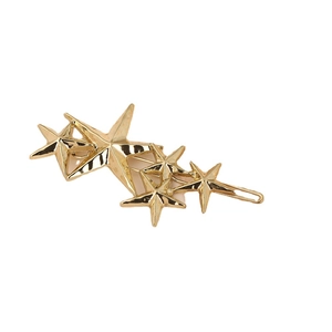 Golden textured star hair clip with multiple 3D stars on a clean white background
