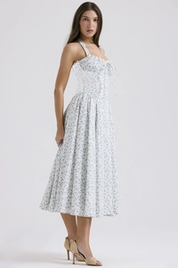 Detail of blue floral print and slim-fit waist on a white summer midi dress