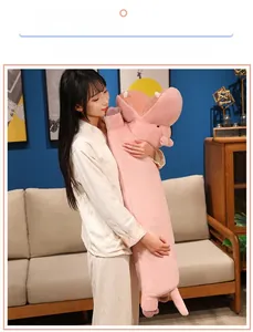 Detail of soft pink hippo plush long pillow being held to show size and plush material