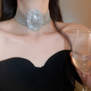 Macro view of luxurious silver rhinestone choker with large oval crystal on model