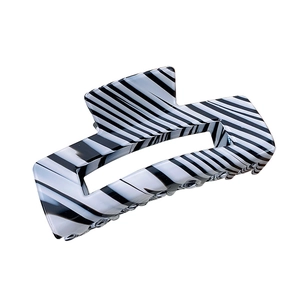 Vintage black and white striped large acetate hair claw clip for women in a minimalist style