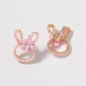 Detail view of pink bunny earrings with small flower accents and white pearl center