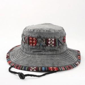 Close-up of vintage washed grey denim bucket hat with ethnic woven tape and wind cord