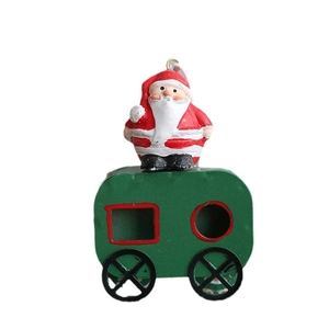 Christmas tree hanging decoration with Santa Claus on green iron train carriage