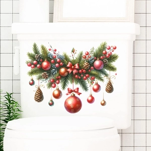 Detail of Christmas toilet sticker with red ornaments, pine branches and brown pinecones