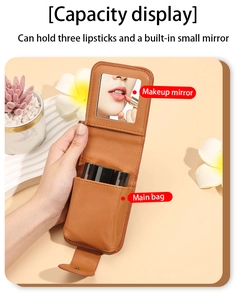 Detail of compact leather lipstick pouch with built-in mirror holding three lipsticks