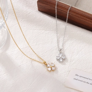 Elegant gold and silver four-leaf clover necklaces with heart-shaped zircon pendants