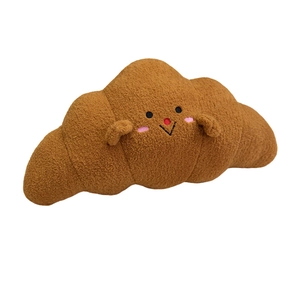 Cute croissant plush pillow with cartoon face and soft faux sheepskin texture