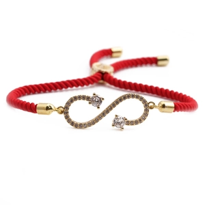Adjustable red rope bracelet with golden infinity symbol and pavé set crystals