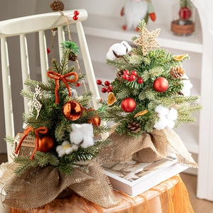 Mini tabletop Christmas tree with red ornaments and burlap base for holiday home decor