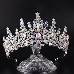 Detailed view of silver birthday crown with colorful rhinestones on a glass stand