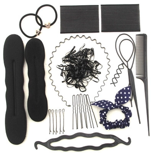 Flat lay of professional black hair styling tool kit with bun makers and accessories