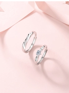 Detailed view of S925 silver couple rings featuring heart zircon and twisted band design