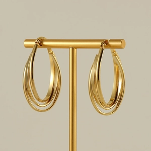 Minimalist gold 18k triple layer chunky hoop earrings on a T-bar jewelry stand