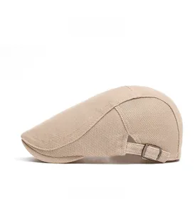Close-up of beige breathable mesh beret with metallic buckle side adjustment detail