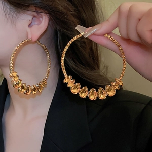 Luxurious geometric oversized gold hoop earrings with amber crystals and pave diamonds
