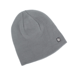 Detail of the grey knit beanie featuring a small square logo patch on fine ribbed fabric