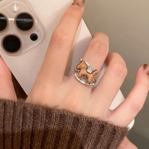 Macro detail of wooden rocking horse ring with zircon stones on silver base
