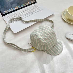 Close-up of a creative baseball cap shaped crossbody bag with pink and green stripes