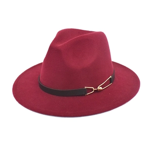Detail of burgundy wool fedora hat featuring a black leather band and gold buckle