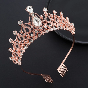 Detail view of a rose gold crystal crown with combs on a black elegant background