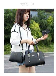 Three-piece black PU leather handbag set with shoulder strap and gold-tone metal hardware