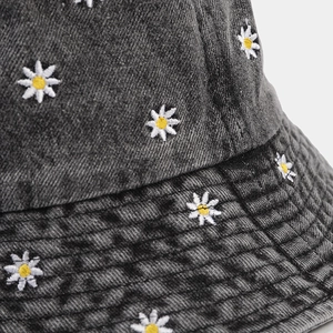 Dark gray denim bucket hat with white daisy embroidery and stitched brim for women