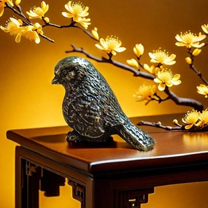 Detail of solid brass bird figurine showing realistic feather textures on a wooden stand