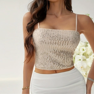 Close-up of sparkling sequin tank top with thin shoulder straps in champagne gold