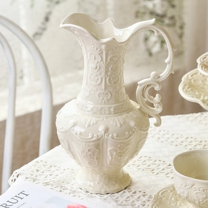 Vintage cream ceramic pitcher with baroque relief patterns for elegant afternoon tea sets