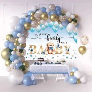 Close-up of Teddy Bear baby shower table set with blue polka dot tablecloth and balloon arch