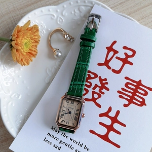 Detail view of retro square women's watch with blue hands and green leather strap