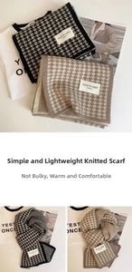 Close-up of knit houndstooth scarf texture with decorative label for winter style