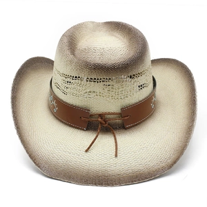 Detail of woven straw cowboy hat featuring brown leather band and intricate turquoise embroidery