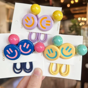 Detailed view of colorful smiley face hair ties with elastic cords on display cards