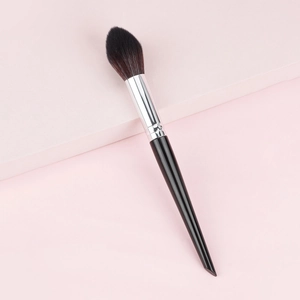 Flame-shaped powder brush with black handle and silver ferrule on pink steps