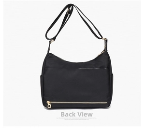 Rear view of black waterproof nylon bag showing adjustable strap and gold metal zipper detail