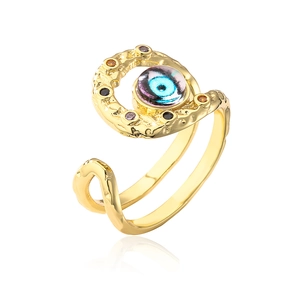 Detailed view of bohemian golden evil eye open ring with blue stones and wavy texture