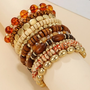 Detail shot of multi-layer bohemian stackable bracelets with amber and gold beads