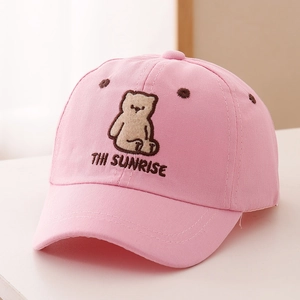Detail of pink cotton baseball cap with embroidered brown bear and THI SUNRISE text