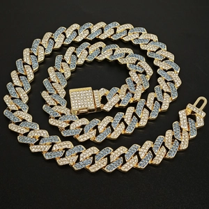 Macro detail of 14mm Cuban link necklace with blue and clear rhinestones on gold plating